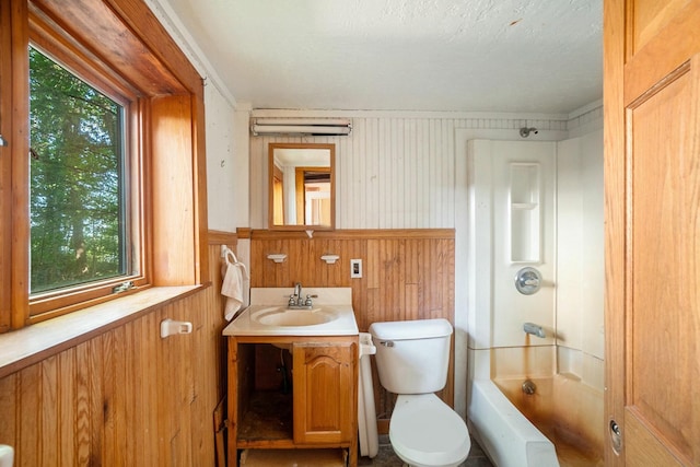 full bathroom with toilet, vanity, wood walls, crown molding, and  shower combination