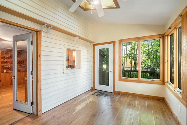 unfurnished sunroom with ceiling fan and lofted ceiling