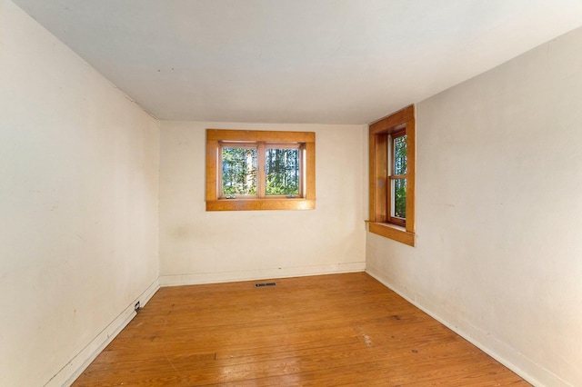 spare room with hardwood / wood-style floors