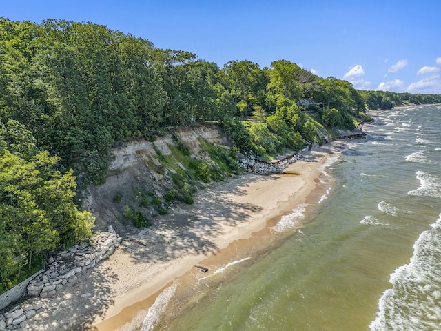 birds eye view of property with a view of the beach and a water view