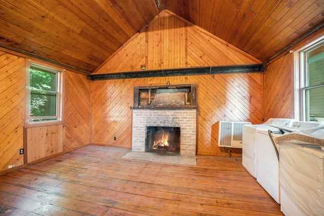 unfurnished living room with lofted ceiling, wood ceiling, separate washer and dryer, and hardwood / wood-style flooring