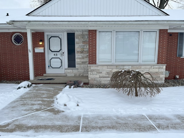 view of snow covered property entrance