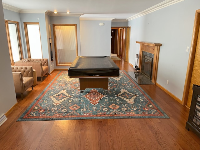 game room with billiards, a fireplace, crown molding, and hardwood / wood-style flooring