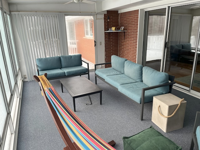 sunroom featuring ceiling fan