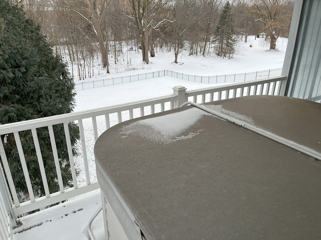 view of snow covered back of property