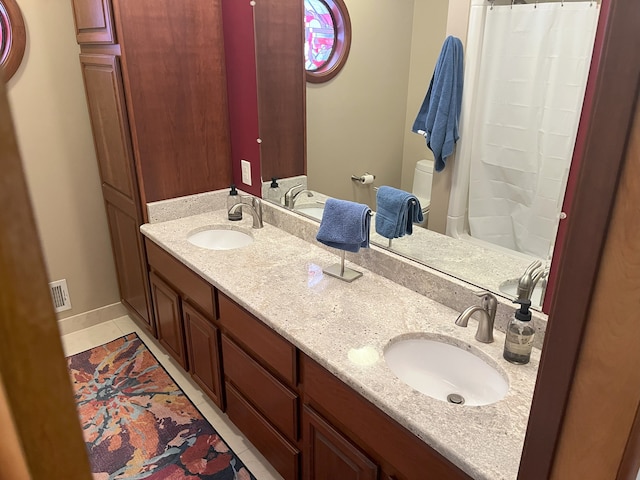 bathroom with vanity and tile patterned flooring