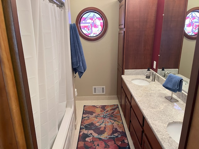 bathroom with tile patterned floors and vanity