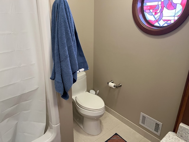 bathroom with toilet, tile patterned floors, and walk in shower