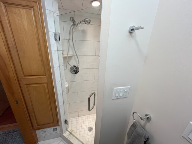 bathroom with tile patterned flooring and a shower with door