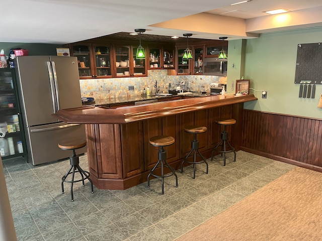 bar with appliances with stainless steel finishes, pendant lighting, and sink