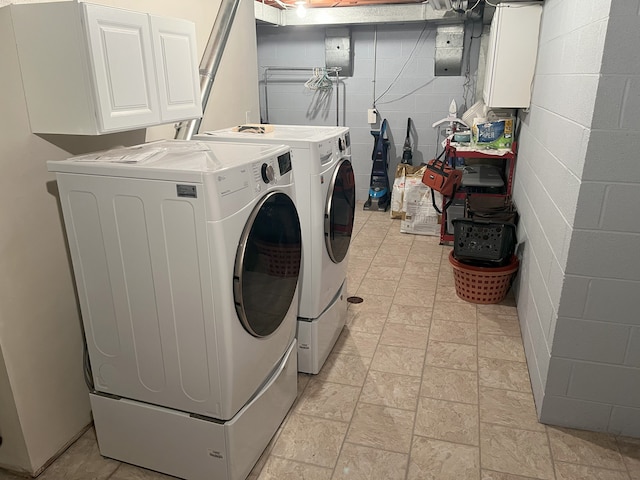 washroom with separate washer and dryer and cabinets