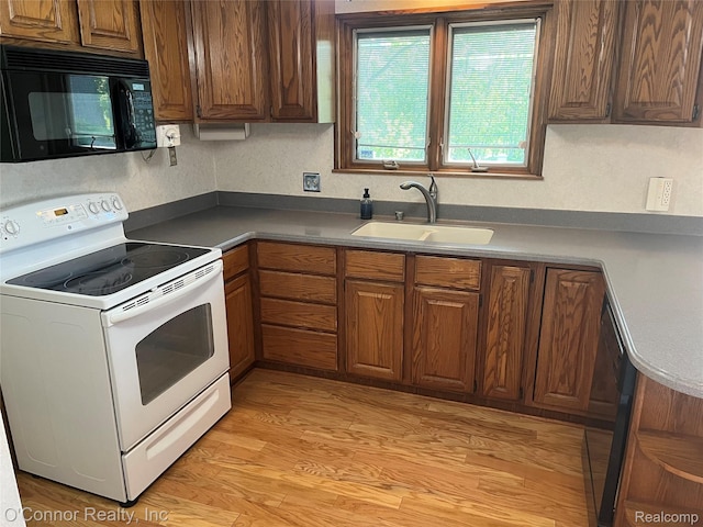 43 W Breitmeyer, Mount Clemens, MI 48043 - kitchen with black appliances, a sink, brown cabinetry, and light wood finished floors