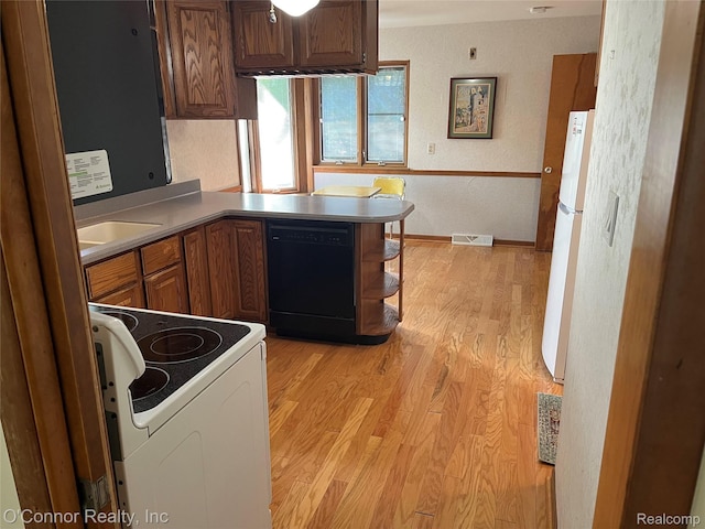43 W Breitmeyer, Mount Clemens, MI 48043 - kitchen with white appliances, light wood-type flooring, a peninsula, brown cabinetry, and a sink