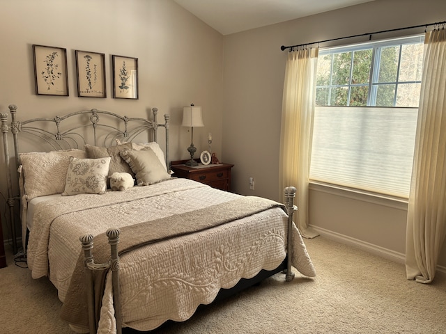 carpeted bedroom featuring vaulted ceiling