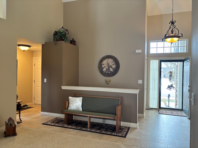 tiled foyer entrance with a high ceiling