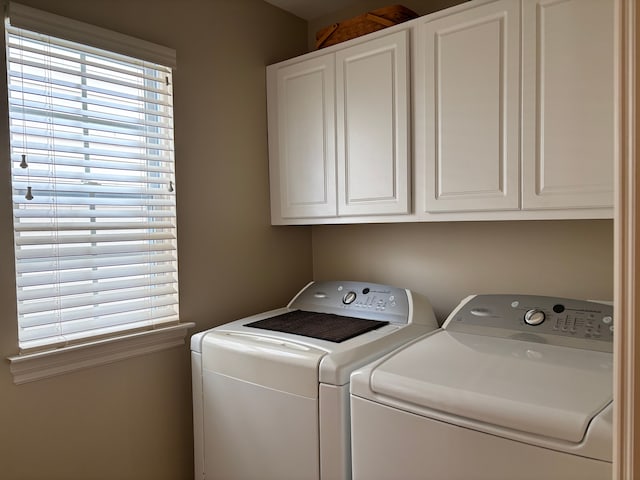 washroom with cabinets and independent washer and dryer