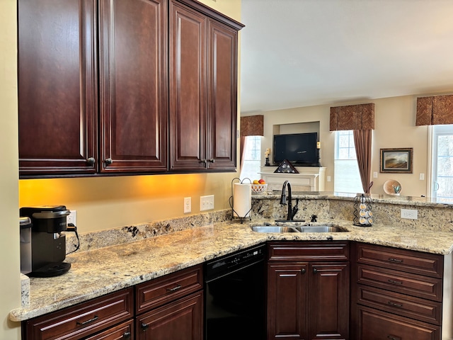 kitchen featuring dishwasher, sink, light stone counters, and kitchen peninsula