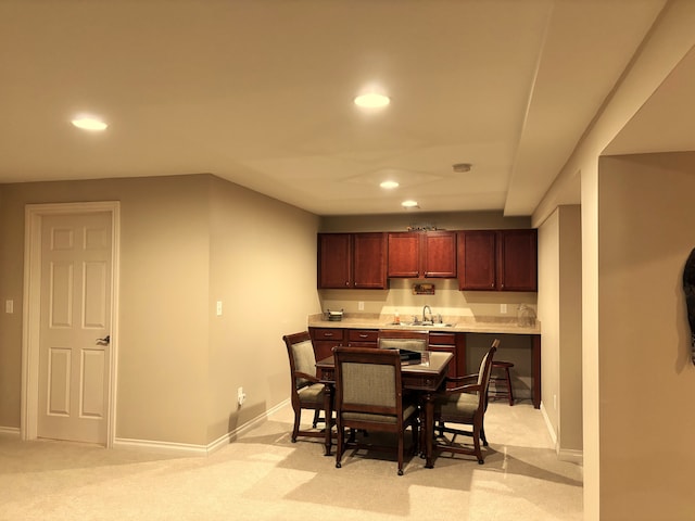 carpeted dining space with sink