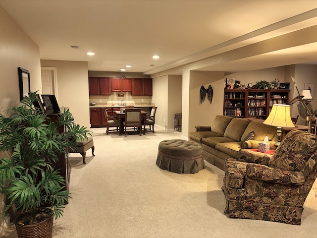 carpeted living room with sink