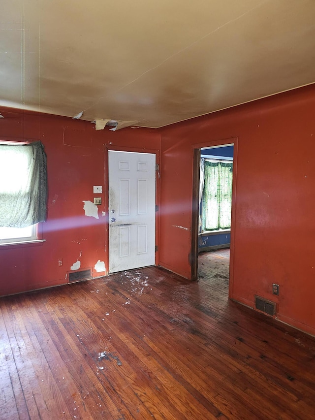 unfurnished room featuring dark hardwood / wood-style flooring