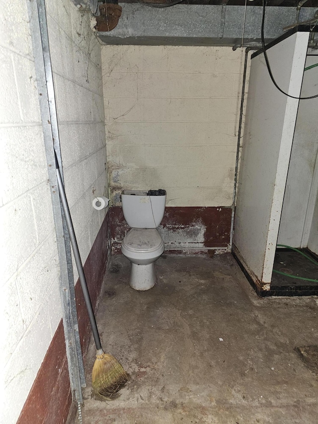 bathroom with toilet and concrete floors