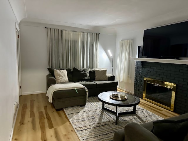 living room with light hardwood / wood-style flooring and a fireplace