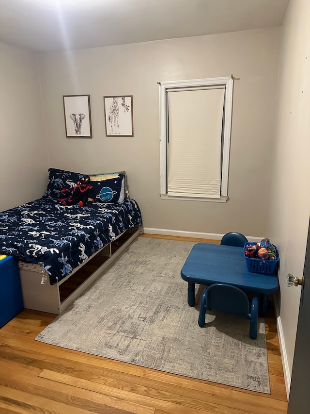 bedroom with hardwood / wood-style floors