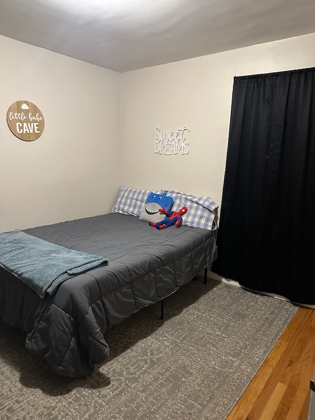 bedroom with wood-type flooring