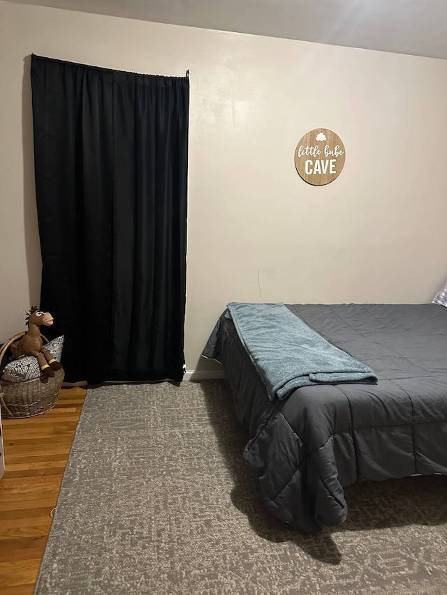 bedroom with hardwood / wood-style flooring