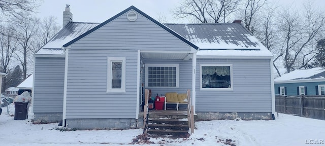 view of snow covered rear of property