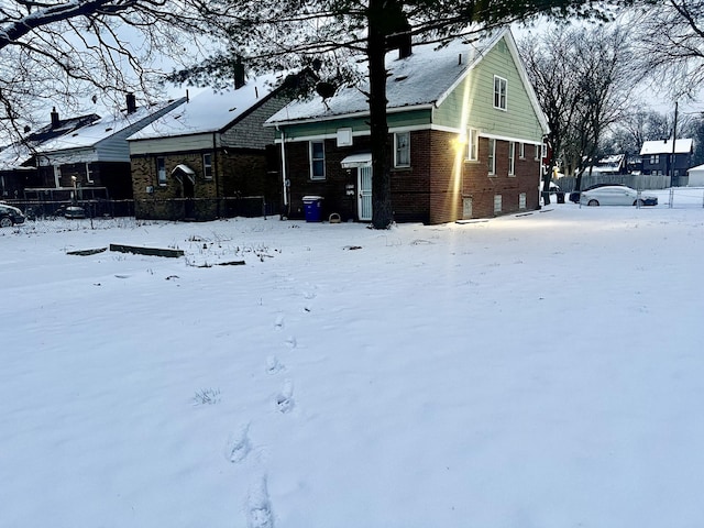 view of snow covered rear of property