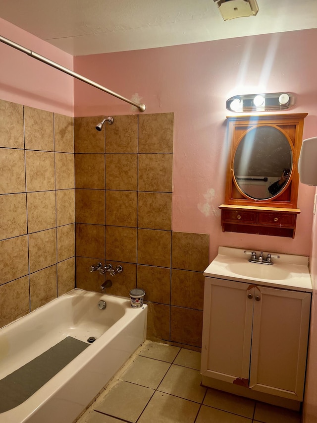 bathroom with tiled shower / bath, tile patterned flooring, and vanity