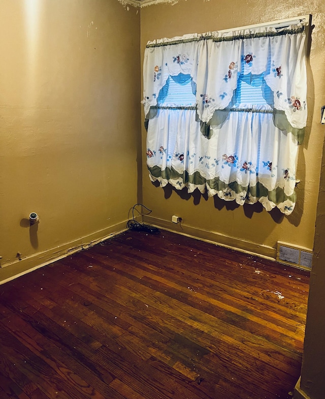 spare room featuring dark hardwood / wood-style flooring