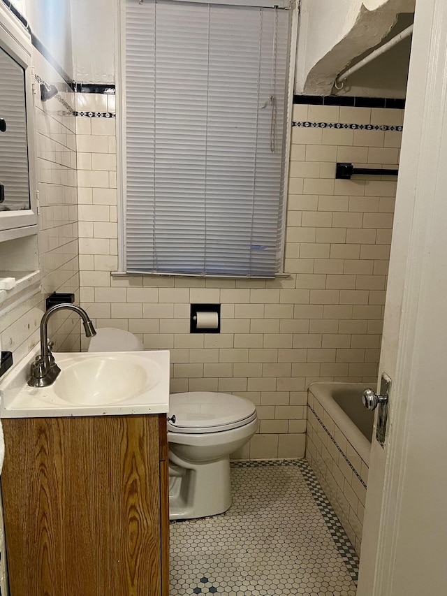 bathroom featuring tile walls, tile patterned floors, vanity, and toilet