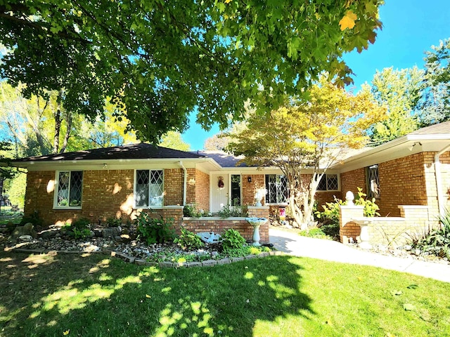 ranch-style home with a front lawn