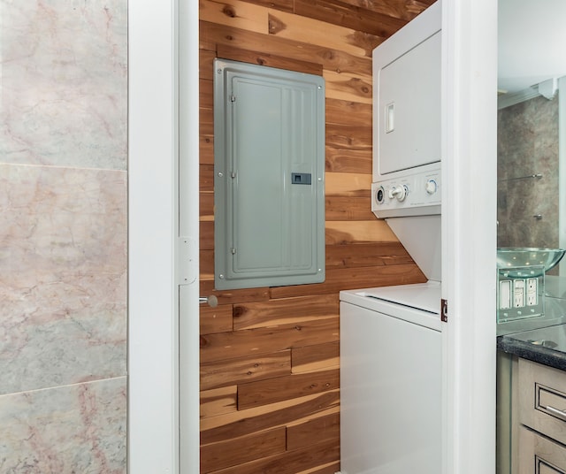 8200 E Jefferson Ave Unit 1811, Detroit, MI 48214 - clothes washing area featuring stacked washer / dryer, electric panel, and wooden walls