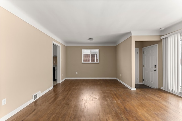 empty room with dark wood-type flooring