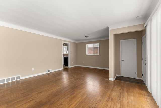 unfurnished room featuring dark wood-type flooring