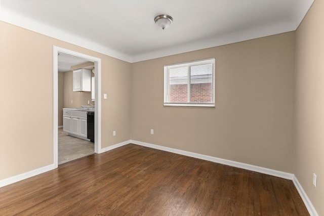 unfurnished room with dark hardwood / wood-style flooring