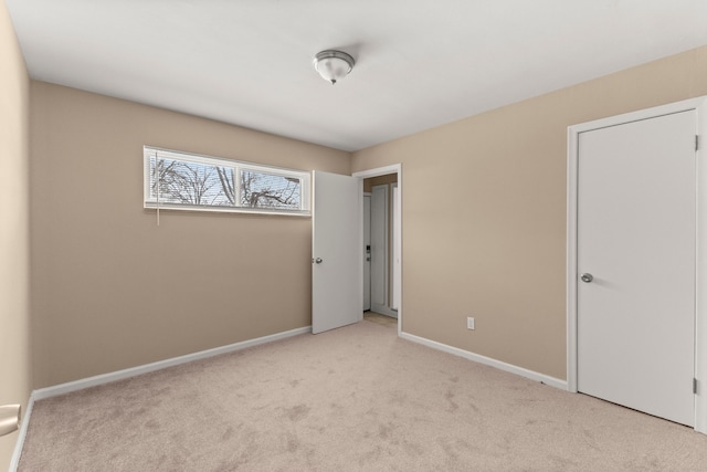 unfurnished bedroom featuring light carpet