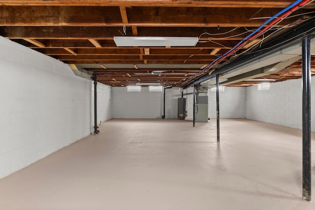 basement featuring heating unit and water heater