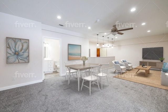 carpeted dining space featuring ceiling fan