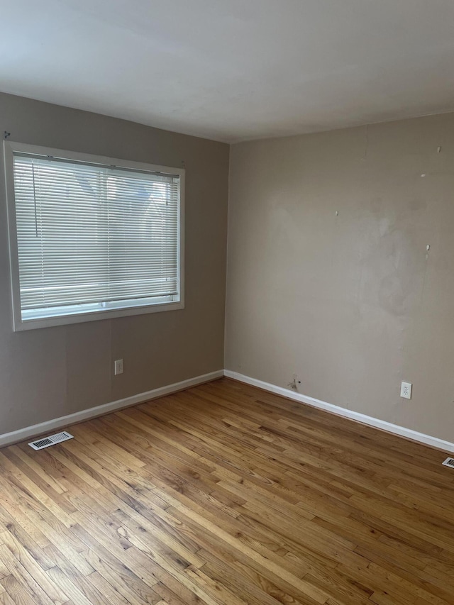 unfurnished room with light hardwood / wood-style flooring