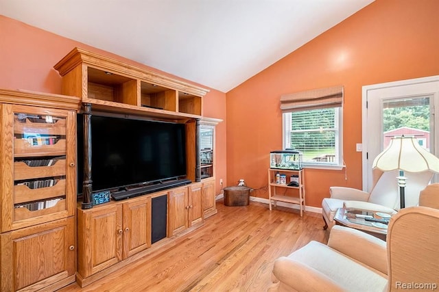 living room featuring lofted ceiling and light wood-type flooring