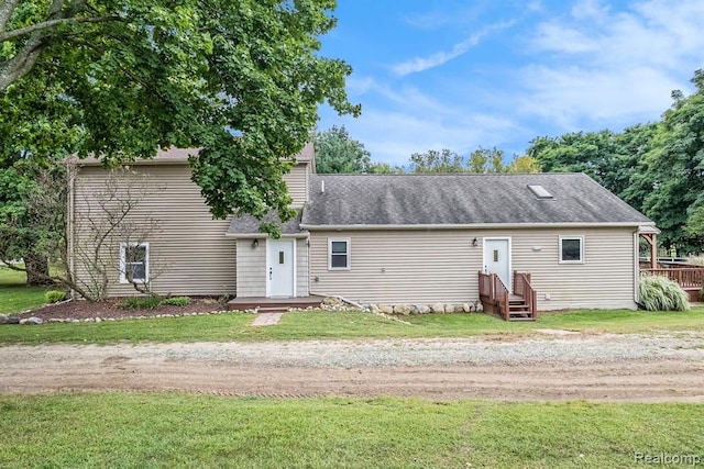 back of property featuring a yard