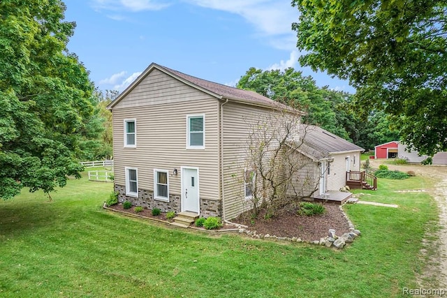 back of property featuring a lawn