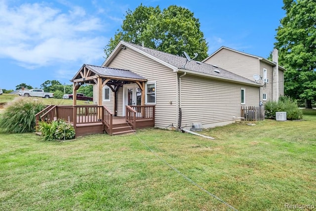 back of house featuring a lawn, a gazebo, and a wooden deck