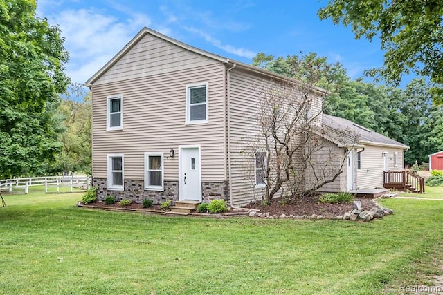 rear view of property with a lawn