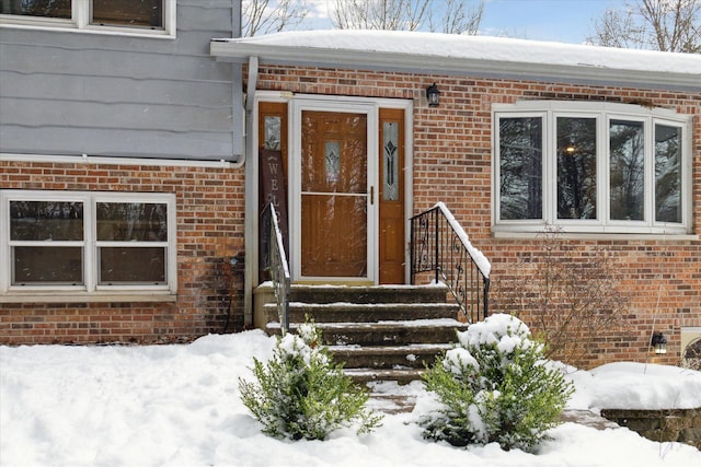 view of snow covered property entrance