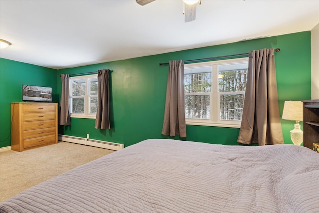 bedroom featuring ceiling fan, a baseboard heating unit, and carpet flooring